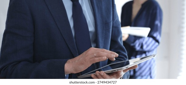 businessman-suit-using-tablet-during-260nw-2749434727